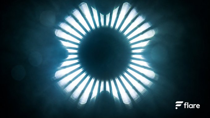 The image features a large white circle with numerous small lines radiating outwards from its center, creating an interesting visual effect that resembles a starburst pattern or a sunburst design. The background of the image is dark blue, which contrasts with the white circle and adds depth to the overall composition. The caption below the image reads "14 years of the XRP Ledger proving the rails work. Fast. Battle-tested. Built for real value movement.FXRP turns them into productive onchain financial infrastructure." This text provides context about the image, suggesting that it is related to a discussion or analysis of the XRP Ledger and its impact on the financial world.