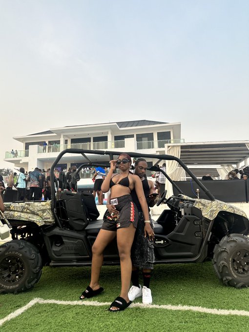 A woman in a black bikini top and skirt poses in front of a Yamaha UTV (side-by-side) with camo accents, while a man stands behind her, capturing a moment at what appears to be an outdoor daytime gathering—setting the scene for a relaxed weekend post about taking a break to recharge with his partner.