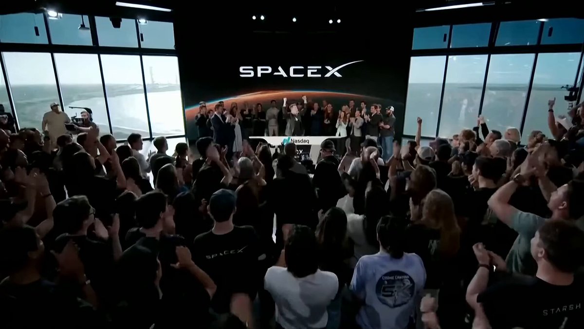The image shows a large crowd of people gathered around a stage, with some individuals holding up their phones or cameras to capture the moment. The event appears to be related to the launch of a new space project by NASA, as indicated by the presence of a large screen displaying the NASA logo and the words "SPACEX". The crowd is engaged in various activities such as taking photos, recording videos, and celebrating with their friends or family members. The post about the allocation of funds for the space project also suggests that the event has attracted significant interest from the public, who are eager to see the results of this new venture.