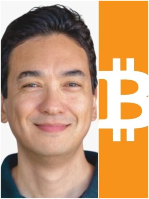 A portrait of a smiling man with dark hair next to an orange panel featuring the white Bitcoin logo.