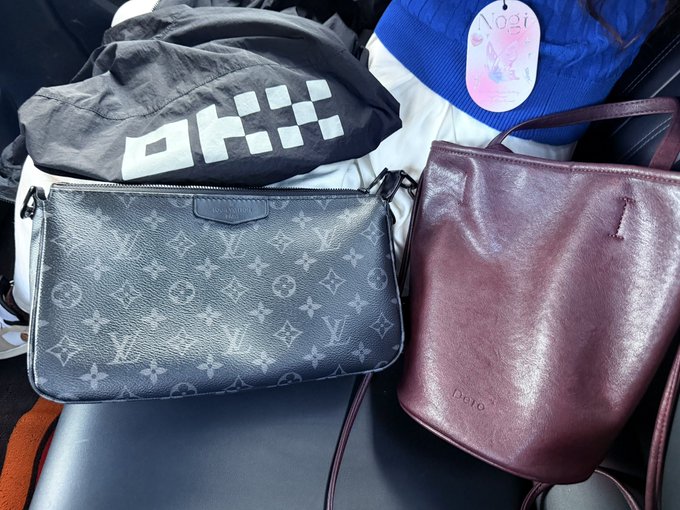 The image shows a comparison between two bags: a small Louis Vuitton monogram pouch and a burgundy Dote bag, alongside a black OKX-branded item and a blue cap featuring a pink tag that reads "No.21" and "GLVZ." This visual aligns with the post's theme of contrasting the poster's affordable Taobao finds with a luxury LV gift, while suggesting that their OKX-branded item holds the most value.