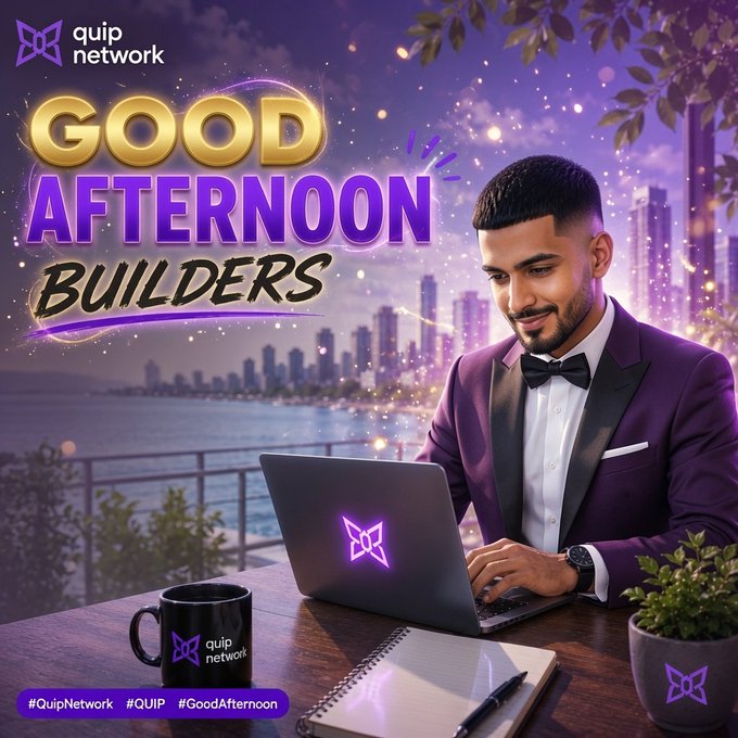 The image features a smiling man in a purple tuxedo working on a laptop displaying the Quip Network logo, with a cityscape and water view in the background, alongside a branded mug and notebook on his desk. Bold text reads "GOOD AFTERNOON BUILDERS" with the Quip Network logo in the top left corner and hashtags "#QuipNetwork #QUIP #GoodAfternoon" displayed at the bottom, perfectly matching the motivational post about consistent building and growing mindshare with $QUIP.