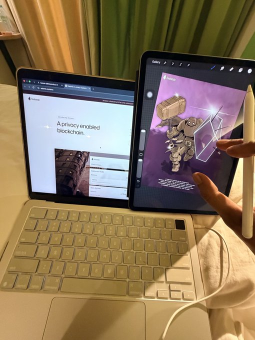 A workspace setup featuring an iPad with keyboard displaying a Fantom blockchain webpage and a second tablet showing NFT artwork, with a person's hand holding an Apple Pencil.