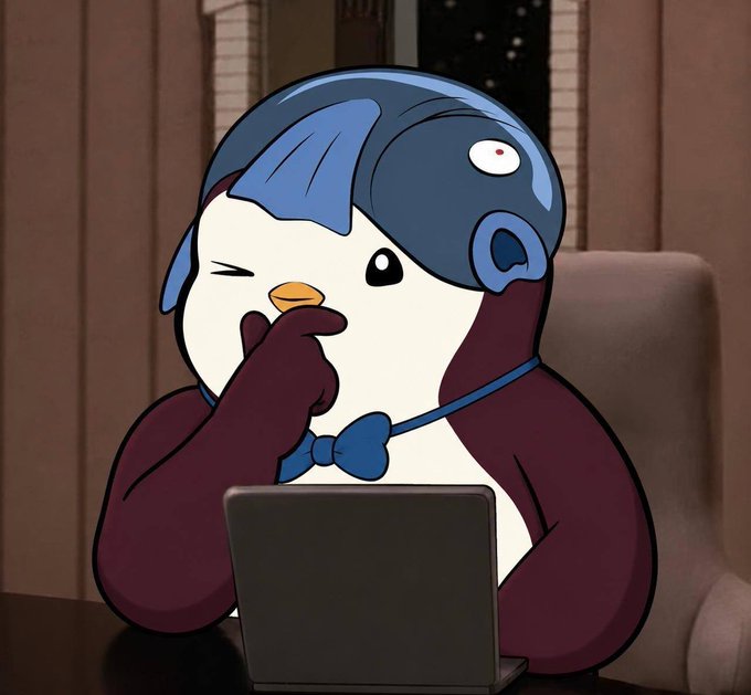 An animated penguin-like character with blue hair and a bowtie sits at a laptop, winking thoughtfully with one hand on its beak.