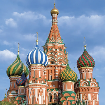 The vibrant onion domes of St. Basil's Cathedral in Moscow's Red Square stand against a blue sky, symbolizing Russia. The image visually anchors the post's news about Russian banks tightening scrutiny on USDT transactions ahead of new crypto regulations effective September 1.