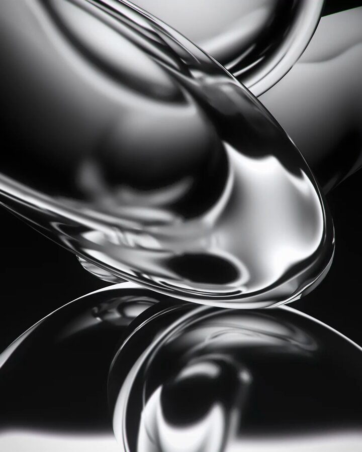 The image features a close-up view of an object with a shiny, reflective surface that appears to be made of glass or metal. It has a unique shape and design, which makes it stand out against the black background. The image does not contain any text or other objects, so its primary focus is on the visual appeal of the reflective surface.