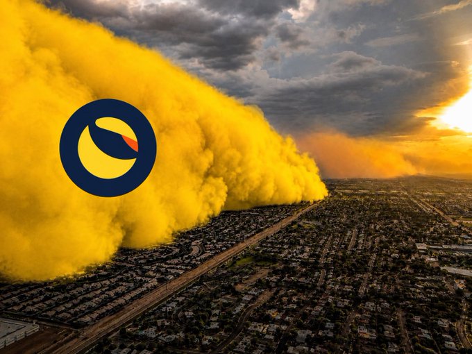 An aerial view of a massive yellow dust storm rolling over a city at sunset, with the TurboTax logo (a blue circle with a yellow and orange leaf-like shape) overlaid on the left side.