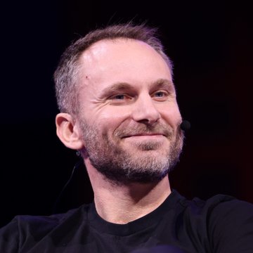 This image shows a man with a beard and a slight smile, likely implying he's being humorous or making a relatable statement about the rapid growth in crypto adoption. It fits perfectly with the post's lighthearted jest about a dog having multiple crypto wallets.