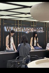 Two tall, fair-skinned women in black dresses work as cashiers at a Walmart station, with a customer pushing a shopping cart toward them. The "Walmart" logo and Chinese characters are visible on the wall behind the counter, supporting the post's humorous observation about strikingly tall, beautiful women employed as store clerks.