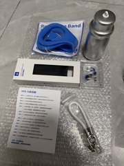 A collection of items laid out on bubble wrap including a blue headband, a silver thermos/tumbler, a black rectangular case, a lanyard, and a printed product specification sheet.