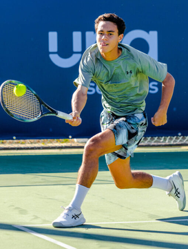 The image shows tennis player Hanlei Lu, wearing a green Under Armour shirt and patterned shorts, lunging forward on a hard court to hit a forehand shot with a tennis ball mid-air near his racket. The background displays "UNO" text, suggesting a tournament sponsor, directly connecting to the post about a Polymarket trader's successful bet on Lu's match at 56.7¢ for a $158.1K profit.