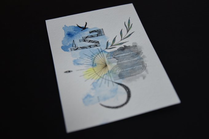 A piece of artwork on white paper featuring blue watercolor clouds, the text 'IM Fine', a sunburst, and green leaves against a black background.