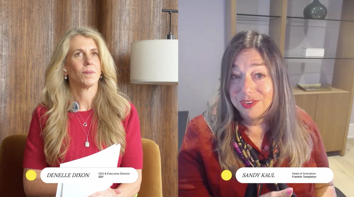 The image shows two women sitting next to each other, both wearing red tops. They are engaged in a conversation or panel discussion about something related to real estate transactions. The woman on the left side of the image has blonde hair and is holding a piece of paper, while her companion on the right side also has blonde hair but does not have any visible papers.