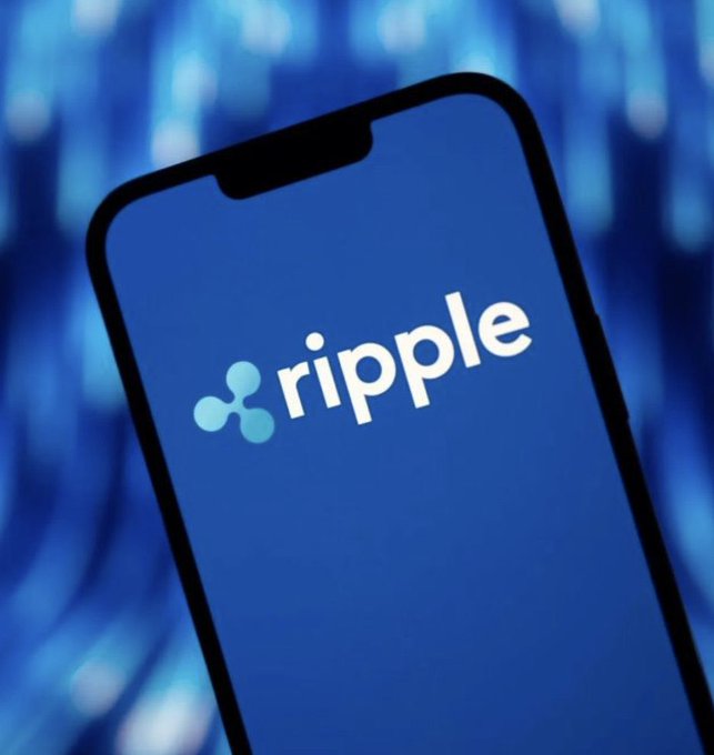 A smartphone displaying the Ripple logo and branding against a blue blurred background.