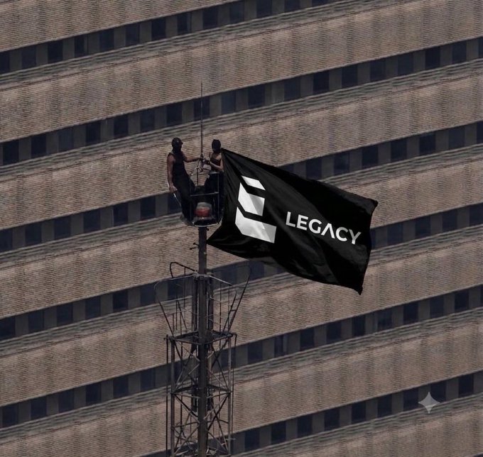 Two people stand in a cherry picker next to a tall building, raising a black flag with the logo 'LEGACY' on it.