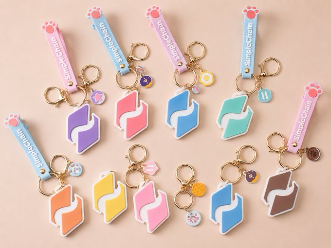An assortment of pastel-colored "SimpleChain" keychains featuring stylized fox/animal head designs in various colors including pink, purple, blue, green, orange, yellow, and brown.