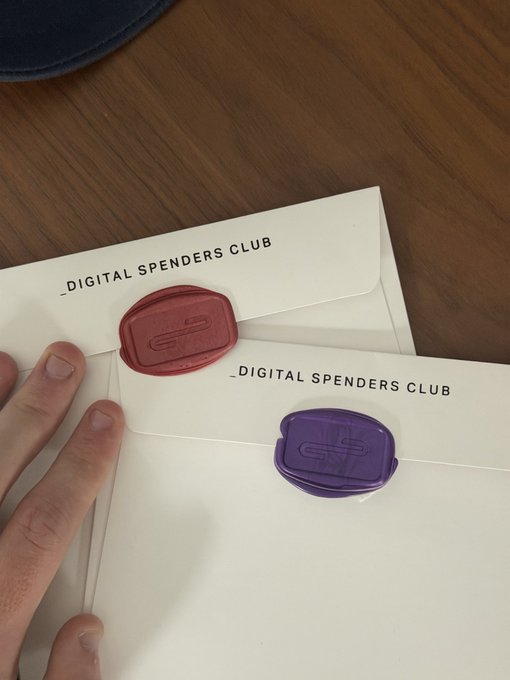 Two white envelopes labeled '_DIGITAL SPENDERS CLUB' sealed with red and purple wax stamps featuring an 'S' logo.