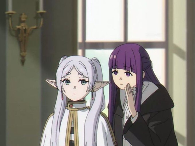 Two anime girls — one with long silver hair and pointed elf-like ears, the other with purple hair leaning in to whisper — stand in a dimly lit room with tall windows and a wall sconce. The whispering girl appears to be sharing a secret warning, fitting the post's theme about an underappreciated, quietly whispered risk of a Tokyo megaquake affecting Hyperliquid.