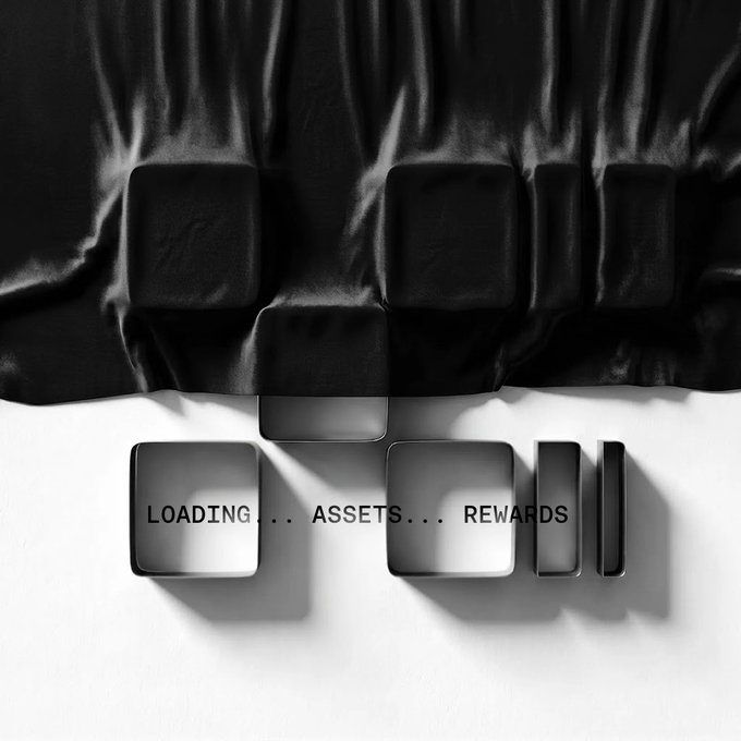 The image shows black fabric draped over cube-shaped objects that appear to be a loading screen, with the text "LOADING... ASSETS... REWARDS" displayed on white square panels below, symbolizing the anticipation of X Layer's upcoming RWA launch and rewards reveal.