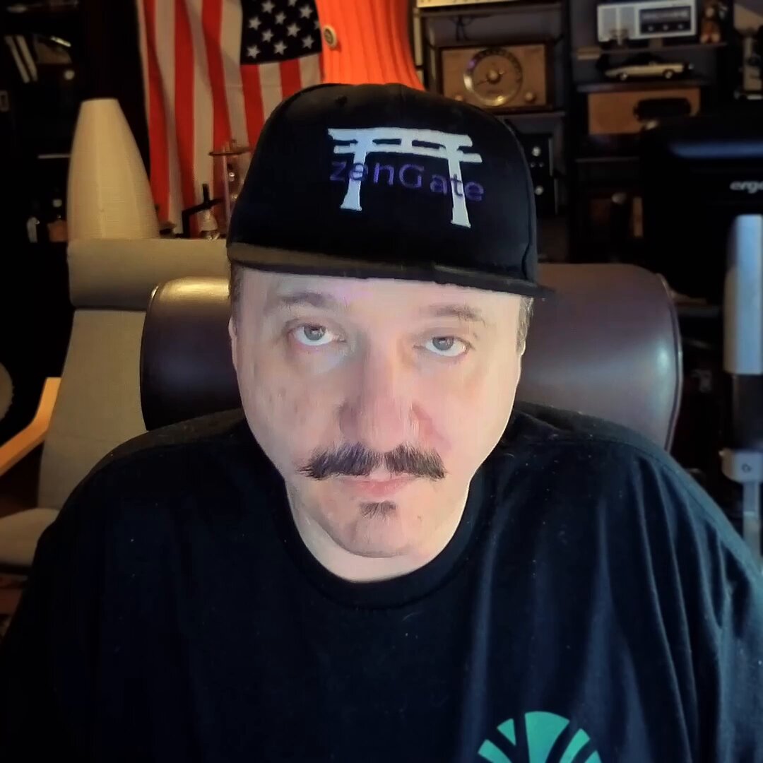 The image features a man wearing a black t-shirt with a green circle on it, sitting down and looking at the camera. The caption reads "This is the adoption story Cardano has been waiting for Not another abstract use case. Agriculture may become one of Cardano's biggest paths to mainstream adoption." This statement suggests that the man might be referring to the agricultural industry or the concept of agriculture in general as a potential path towards mainstream adoption, possibly using the image and its context to support his point.