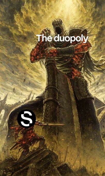 An epic fantasy illustration of two armored warriors in a dramatic embrace or battle pose, with the text "The duopoly" overlaid near the top and a black circular "S" logo in the lower portion. The dark, fallen-warrior figure wielding a sword against the towering armored figure mirrors the post's "real ones never left" sentiment, suggesting a lone true challenger standing defiant against an overwhelming dominant pair.