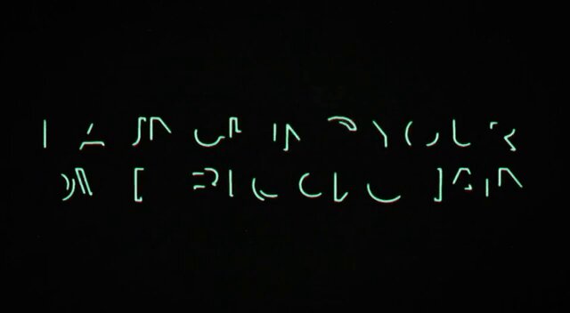 The image features a neon sign with text written in an unknown language that reads "I am up in the cycle of your life". The background of the image is black, which contrasts with the glowing neon letters. The text appears to be in a foreign language or script, adding an element of mystery and intrigue to the overall composition.