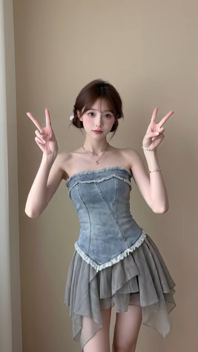 A young woman in a strapless denim corset top and flowy gray skirt flashes double peace signs, her upbeat pose mirroring the celebratory vibe of the post about Bitcoin's overnight price surge.