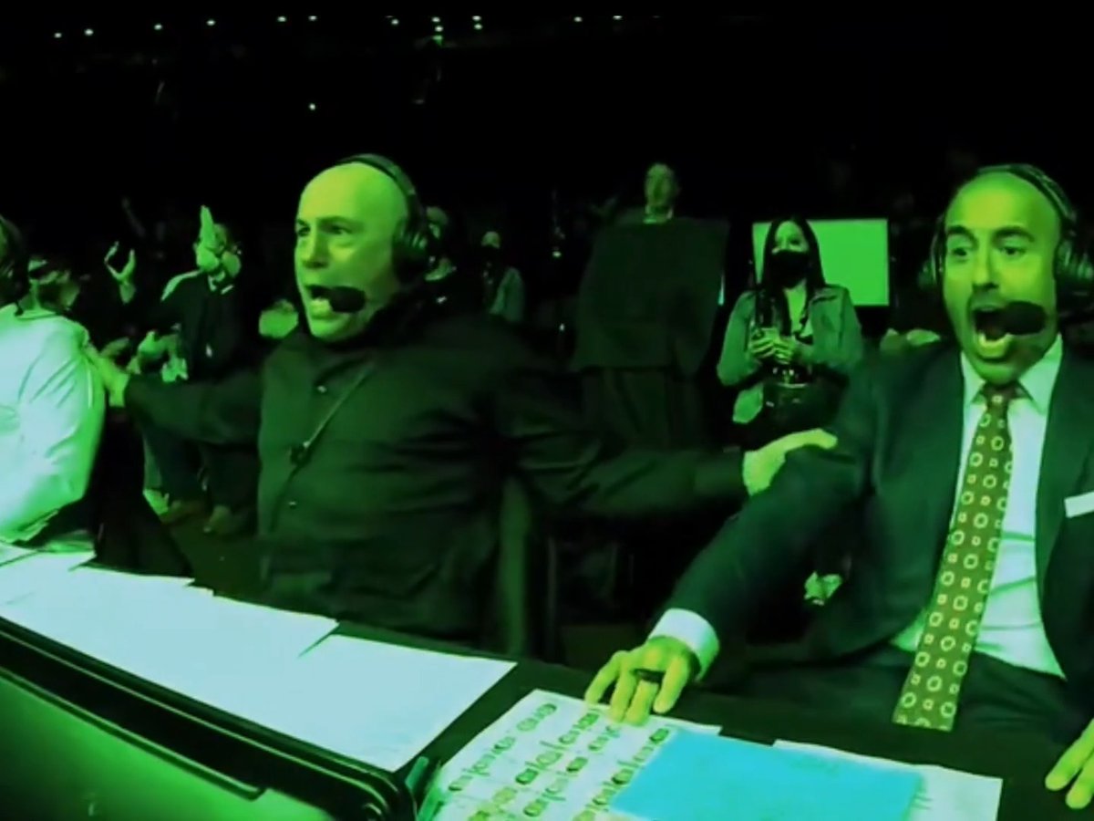 Two sports commentators wearing headsets react with exaggerated shock and excitement at a desk, bathed in dramatic green arena lighting, while spectators are visible in the dim background. The image humorously mirrors the "How crypto holders are moving this week" post by depicting the frantic, over-the-top emotional reactions of broadcasters, playfully equating commentators' animated outbursts to the volatile price swings experienced by crypto traders.