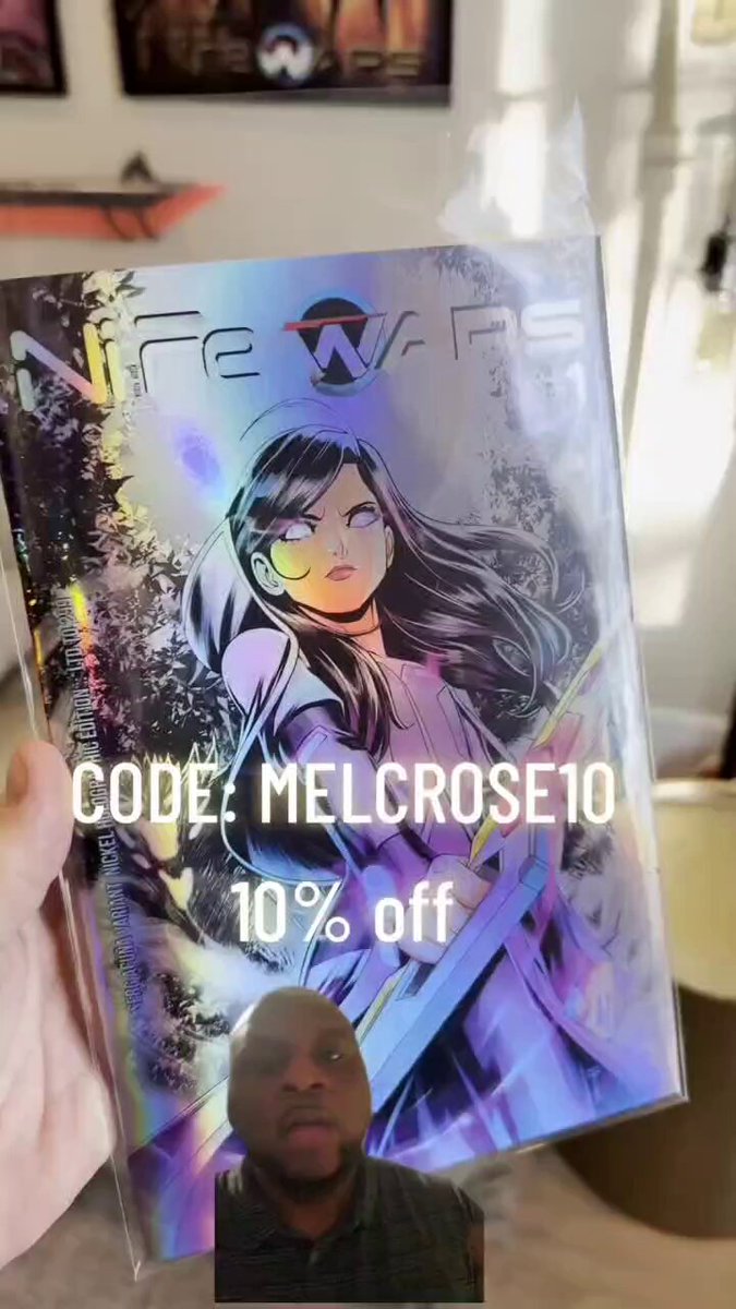 A man is holding a book titled "Herro Cryptos" that seems to be a comic or novel related to a cryptocurrency called Melcrose. The book is wrapped in plastic and has a 10% off offer, which suggests that the price of the book may have been reduced for customers during a sale.