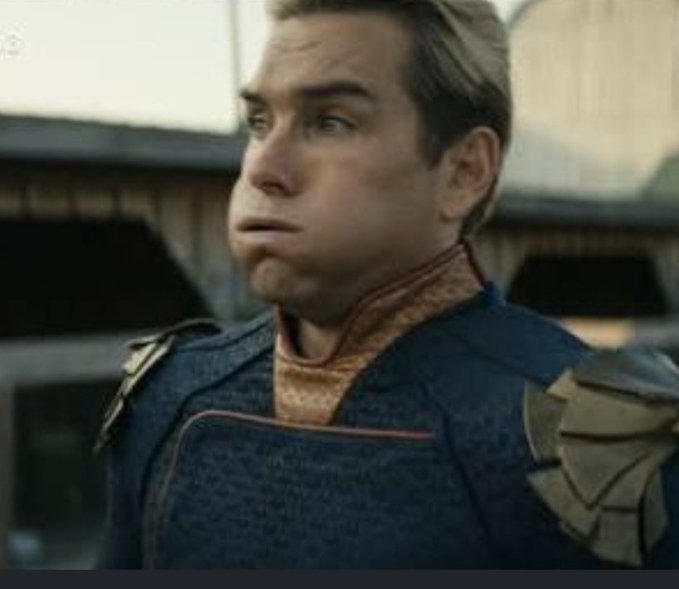 A still from 'The Boys' showing Homelander (Antony Starr) in his superhero costume making an awkward, pouting facial expression.