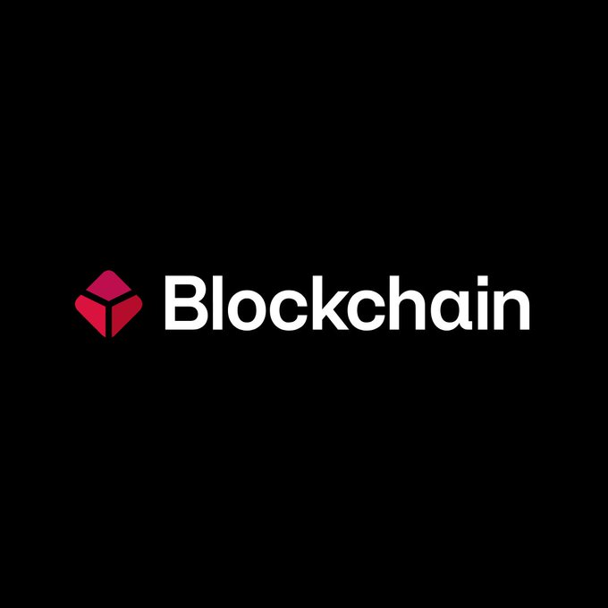 The image displays the Blockchain.com logo, featuring a red and pink cube icon next to the white "Blockchain" wordmark on a black background. This relates to the post about the cryptocurrency platform reportedly pursuing a $500 million IPO at a $4–6 billion valuation.