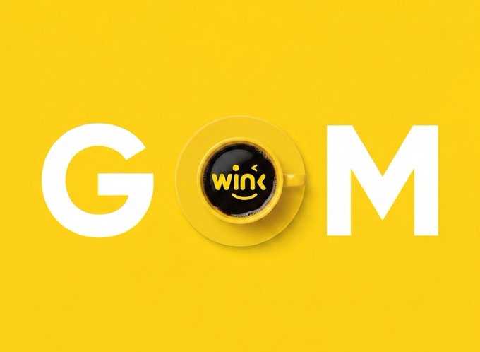 A yellow background with the word "GOM" in large white letters, where the "O" is replaced by a coffee cup with a smiley face containing the word "wink".