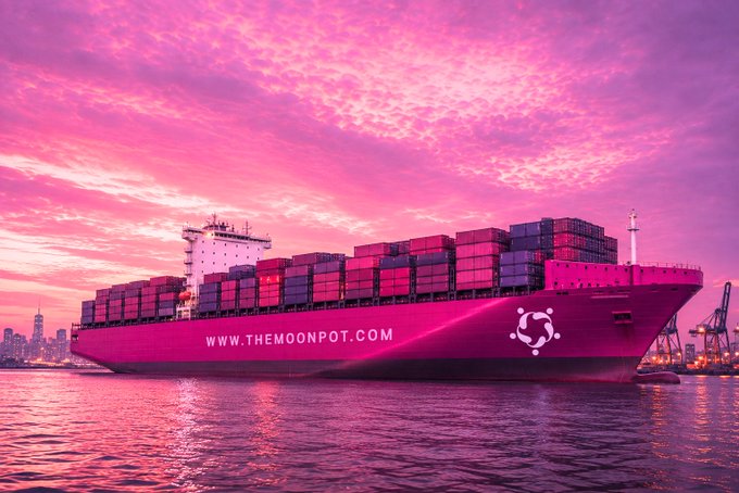 A large pink container ship labeled 'WWW.THEMOONPOT.COM' sails on the water under a vibrant pink and purple sunset sky.