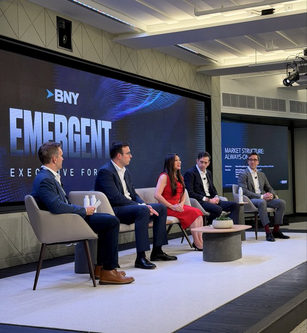 Five panelists sit on a modern stage at the BNY Emergent Executive Forum, with the large screen behind them displaying the event branding alongside a presentation slide titled "MARKET STRUCTURE: ALWAYS-ON," reflecting the discussion on around-the-clock trading with contributors from ICE Markets, Digital Asset, Canton Network, Zero Hash, and others.