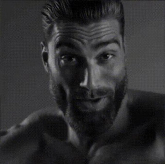 A black-and-white close-up portrait of a muscular, bearded man with slicked-back hair gazes intensely at the camera, his serious expression conveying strong confidence and intensity.

The image appears to relate to the post about "underestimating @LaunchOnSF potential" through its portrayal of someone projecting formidable strength and capability, suggesting that the project has more power and significance than critics realize.