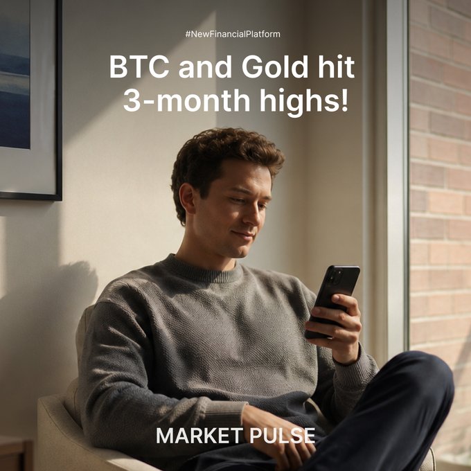 A young man sits relaxed in a sunlit room, smiling at his smartphone as he checks market updates. The overlay text reads "#NewFinancialPlatform" and "BTC and Gold hit 3-month highs!" with "MARKET PULSE" at the bottom, reinforcing the post's theme of Bitcoin and gold reaching new peaks.