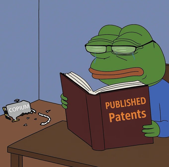 A cartoon of a crying Pepe the Frog wearing glasses and a blue shirt, reading a red book titled "PUBLISHED Patents," with a broken piggy bank labeled "COPIUM" shattered on the table beside him.
