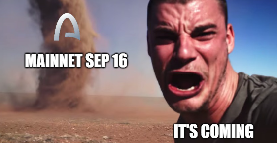 A meme featuring a man with an intense expression shouting in a desert setting with a tornado, with text reading 'MAINNET SEP 16' and 'IT'S COMING' along with an 'A' logo.