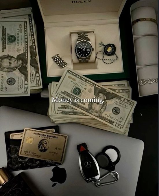A flatlay displaying stacks of cash, a Rolex watch, a Mercedes car key, a wallet with an American Express card, and a Gucci-patterned item, overlaid with the text "Money is coming".