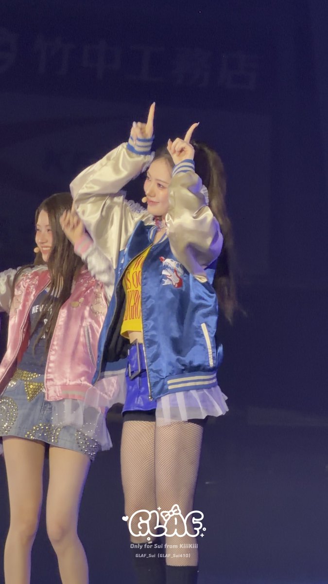 Two performers dance on stage; one wears a blue satin jacket and makes a finger heart gesture, while the other wears a pink jacket. A watermark reads 'Only for Sui from KiiiKiii'.