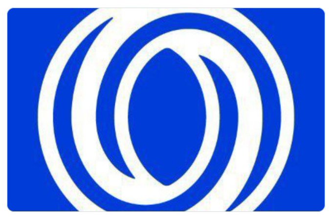 A blue rectangular flag or logo featuring a white circular emblem composed of interlocking crescent shapes surrounding a central leaf or teardrop motif.