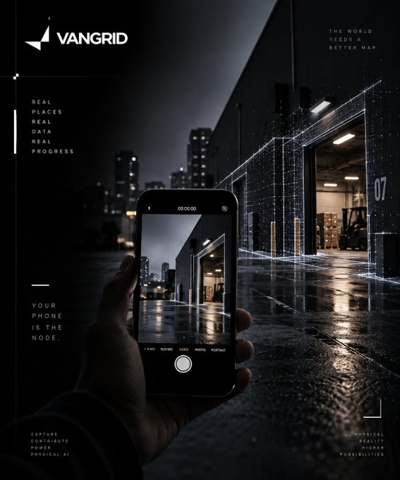 A hand holds a smartphone in camera mode, capturing a dark urban scene where a warehouse is overlaid with glowing wireframe geometry, framed by "VANGRID" branding and slogans like "YOUR PHONE IS THE NODE," "REAL PLACES REAL DATA REAL PROGRESS," and "THE WORLD NEEDS A BETTER MAP." The image visually echoes the post's message—portraying everyday smartphones as distributed sensors building a crowdsourced digital map of the physical world.