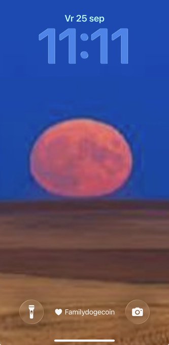 A phone lock screen showing a red moon with the time '11:11' and date 'Vr 25 sep', featuring a 'Familydogecoin' text icon.