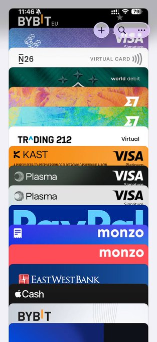 A mobile screenshot showing a digital wallet collection of bank cards including N26, World Debit, Trading 212, Kast, Plasma, Monzo, East West Bank, Apple Cash, and ByBit. The image visually represents the user's growing portfolio of overseas bank accounts and virtual cards mentioned in their progress update, serving as a tangible display of their cross-border financial infrastructure built over two months.