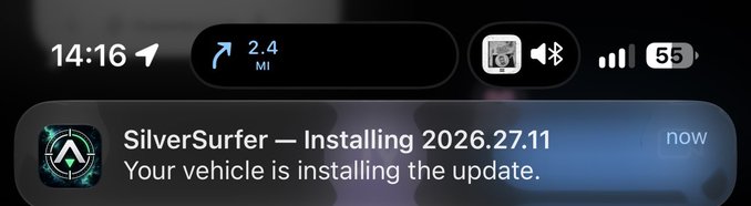 iPhone notification screen showing a time of 14:16, a navigation prompt for 2.4 miles, and a SilverSurfer vehicle update notification reading 'Installing 2026.27.11 - Your vehicle is installing the update.'