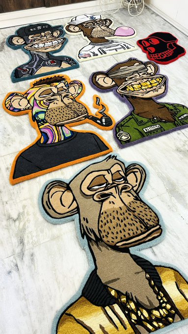 Several colorful cartoon monkey and ape rugs are spread out on a marble floor, featuring characters with grills, hats, and 'POLO' branding.