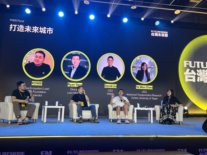 A panel discussion at the 'FM26 Panel: 打造未來城市' (Building the Future City) event, featuring speakers KOWEI, Ryan Yang (Asia Ecosystem Lead, Leap Motion), David Liu (CEO, Web3), and Ya Wen Chen (CEO, Advanced Transportation Research Center, University of Taipei).