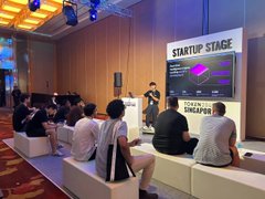 A 'STARTUP STAGE' presentation event where an audience sits on white benches watching a screen displaying a graph, with 'STARTUP SCALING' branding visible.