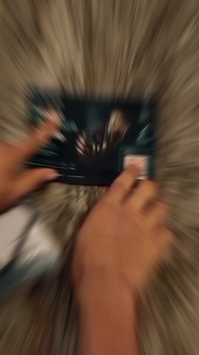 The image shows a person's hands holding a laptop computer with their fingers spread out, indicating that they are using the device for an extended period of time. The background appears blurry, suggesting motion or speed. The caption above the image reads "Focus on what is in the image and how it relates to the post". This implies that the focus should be on the relationship between the person's actions with their laptop and the content displayed on the screen, rather than on the specific details of the device itself.