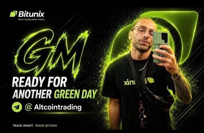 A man wearing glasses and a black Bitunix shirt holds up a smartphone in a selfie-style pose against a dark background featuring a large green arrow. The image promotes Bitunix with text reading "GM," "READY FOR ANOTHER GREEN DAY," and the Telegram handle "@Altcointrading," visually reinforcing the post's message about perseverance and discipline in crypto trading.